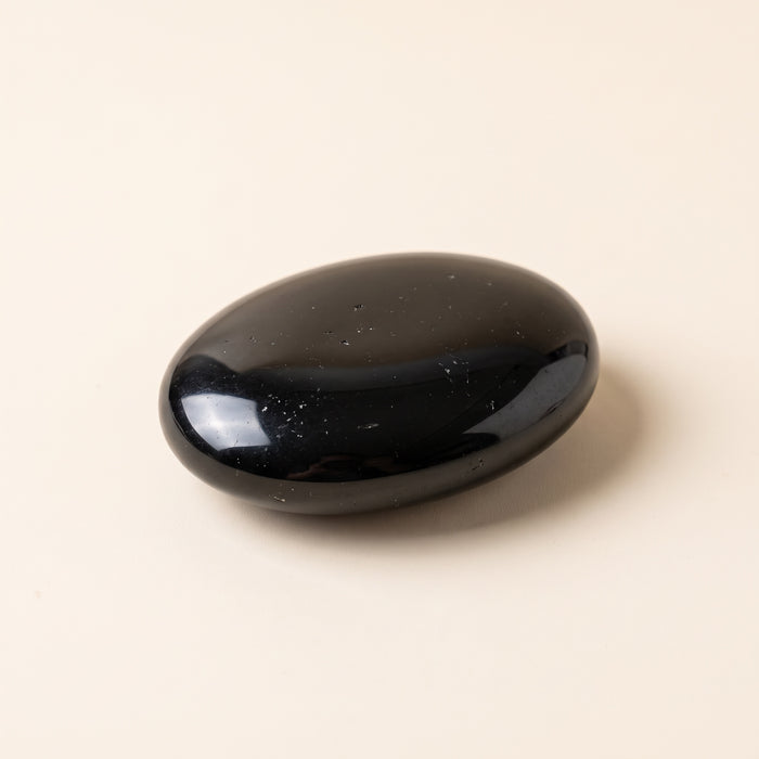 Polished black obsidian palm stone