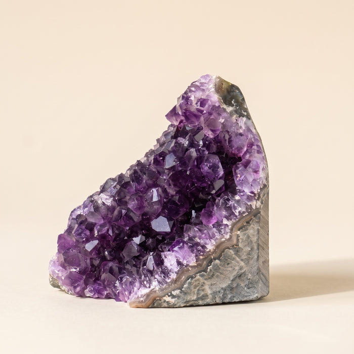 Natural amethyst cluster with grey-white agate rim and flat cut base