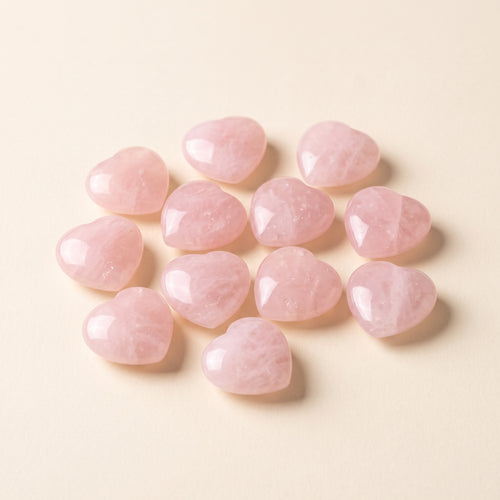 Small polished rose quartz hearts, about 2 cm each