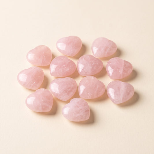 Small polished rose quartz hearts, about 2 cm each