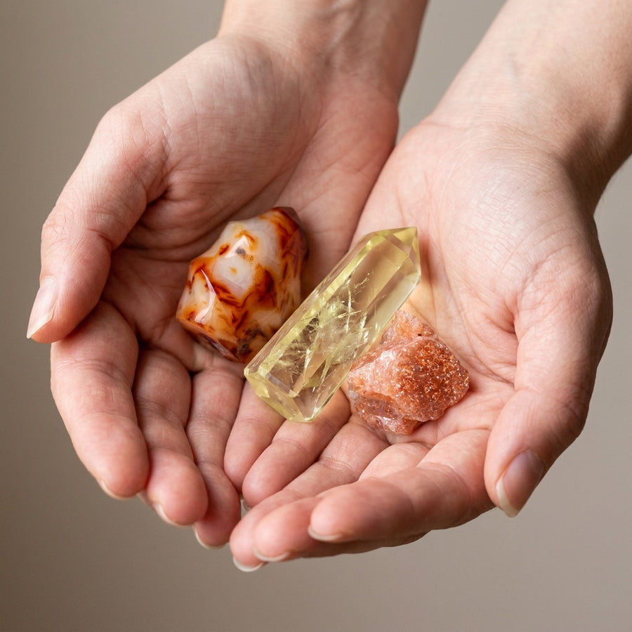 The Creative Spark stones held in cupped hands to show size