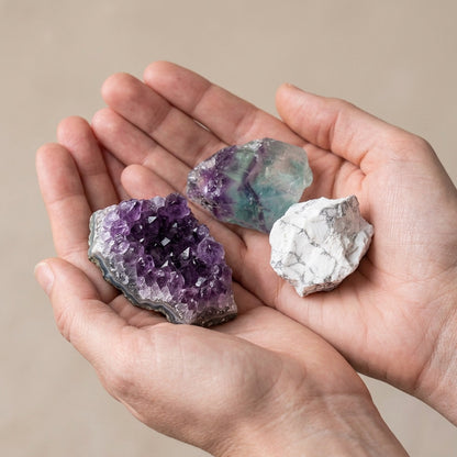 The Overthinker's Reset stones held in cupped hands to show size