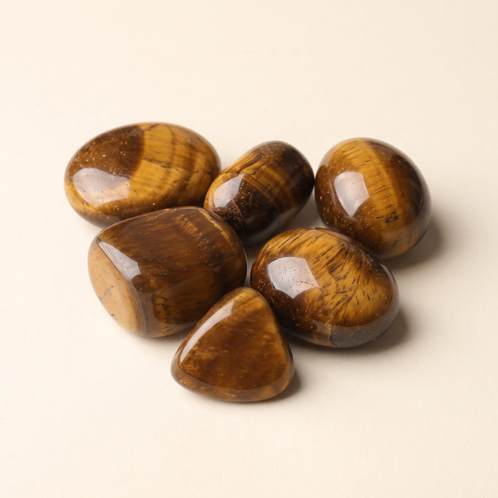 Tumbled tiger's eye stones, golden brown with shimmering bands